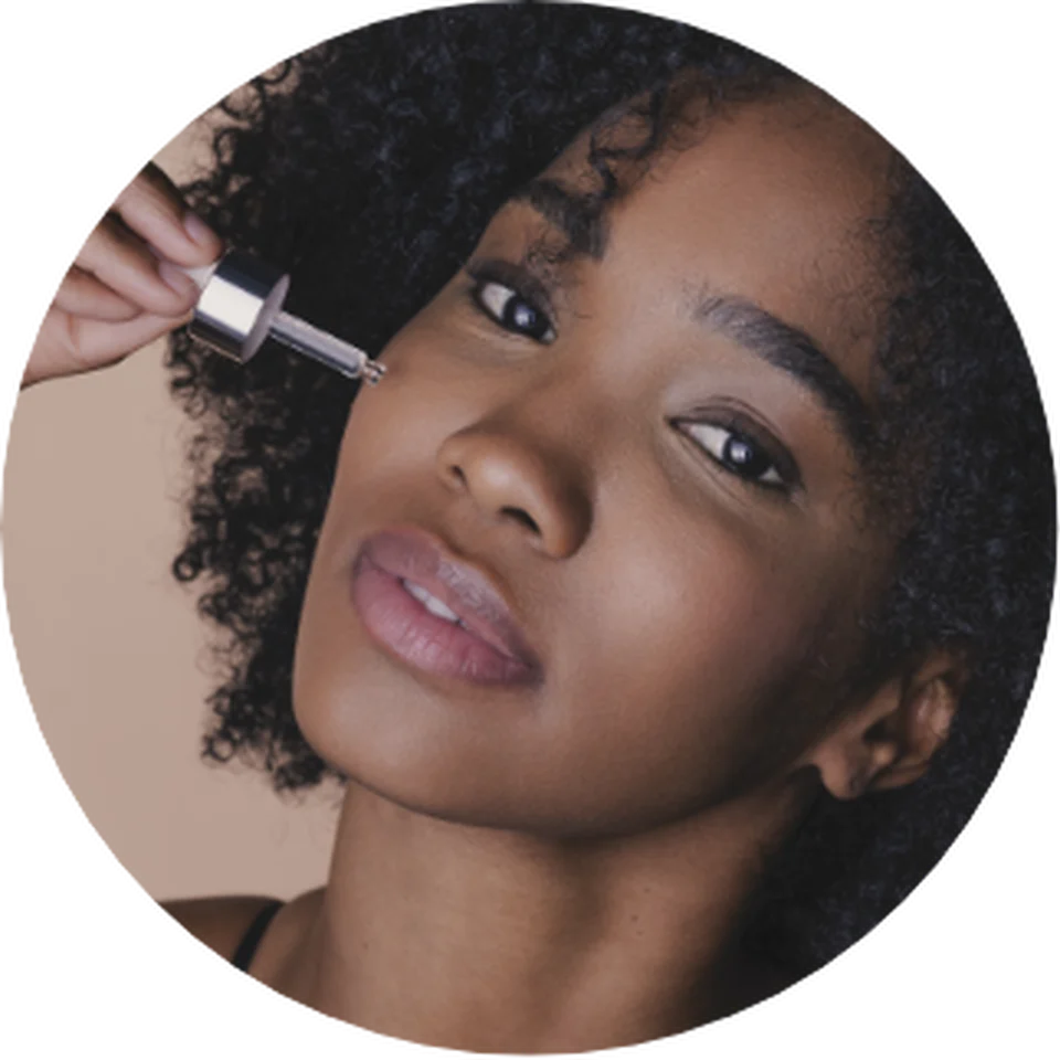 Woman applying Black Rose Precious Face Oil