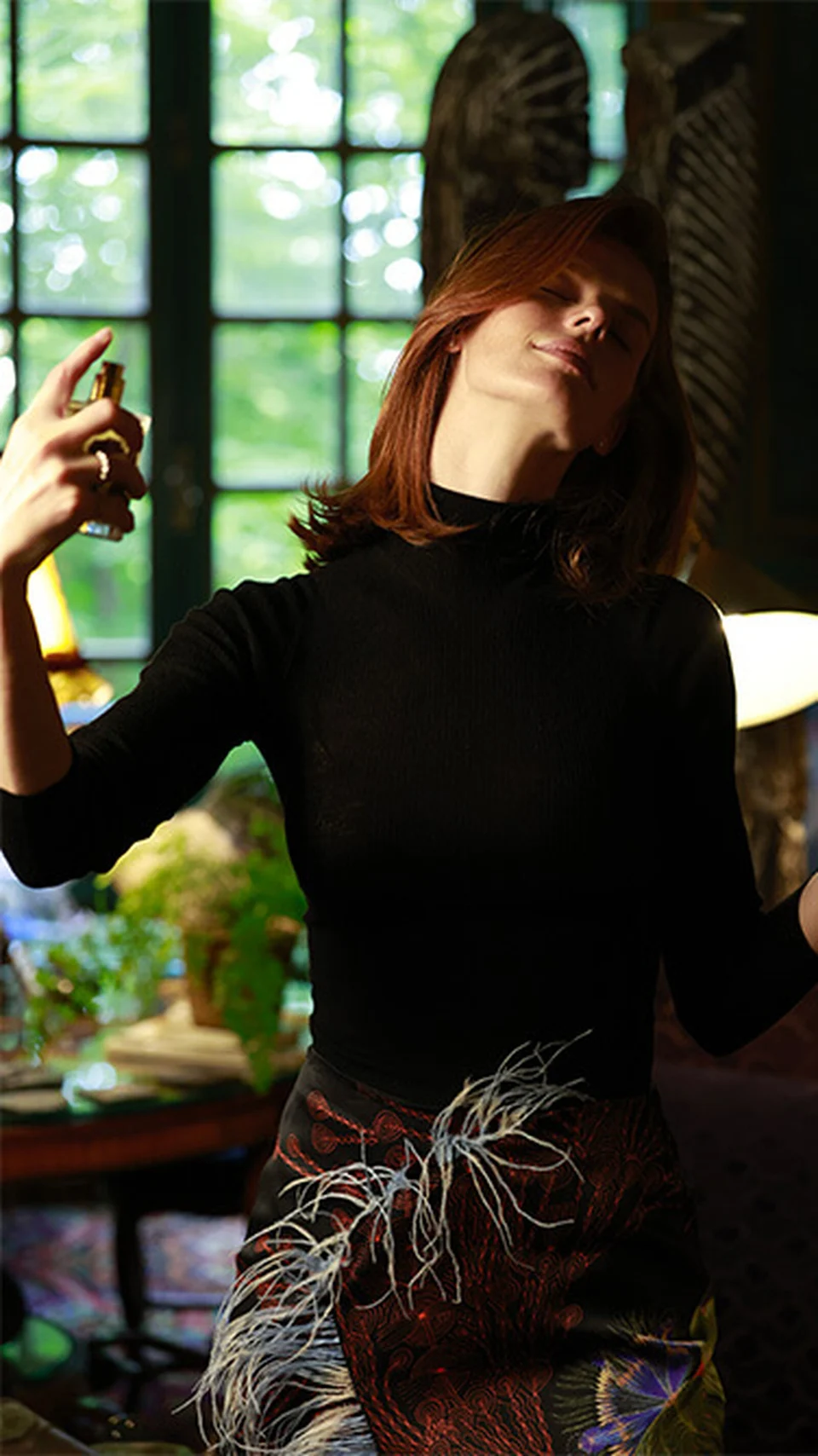 A person putting on Eau du Soir