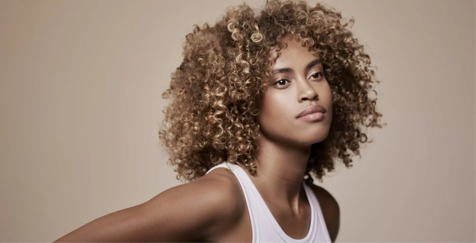 Dirty blonde model with coily hair Intense Nourishment Hair Care Mask