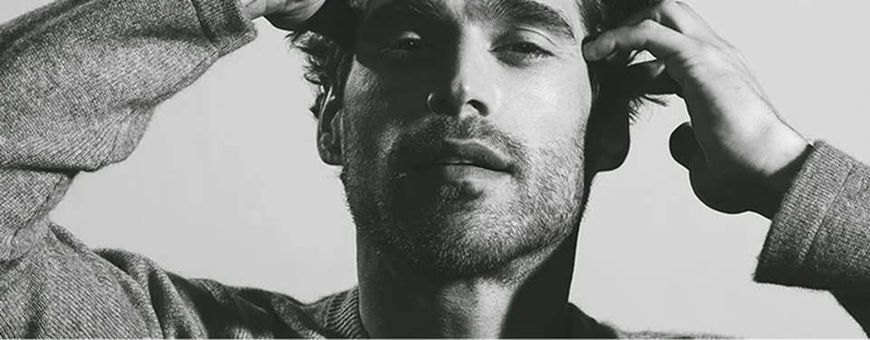 Male model running his fingers through his hair 