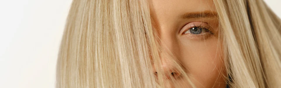 Model with blonde hair with Hair Rituel by Sisley Beautifying Hair Care Mask