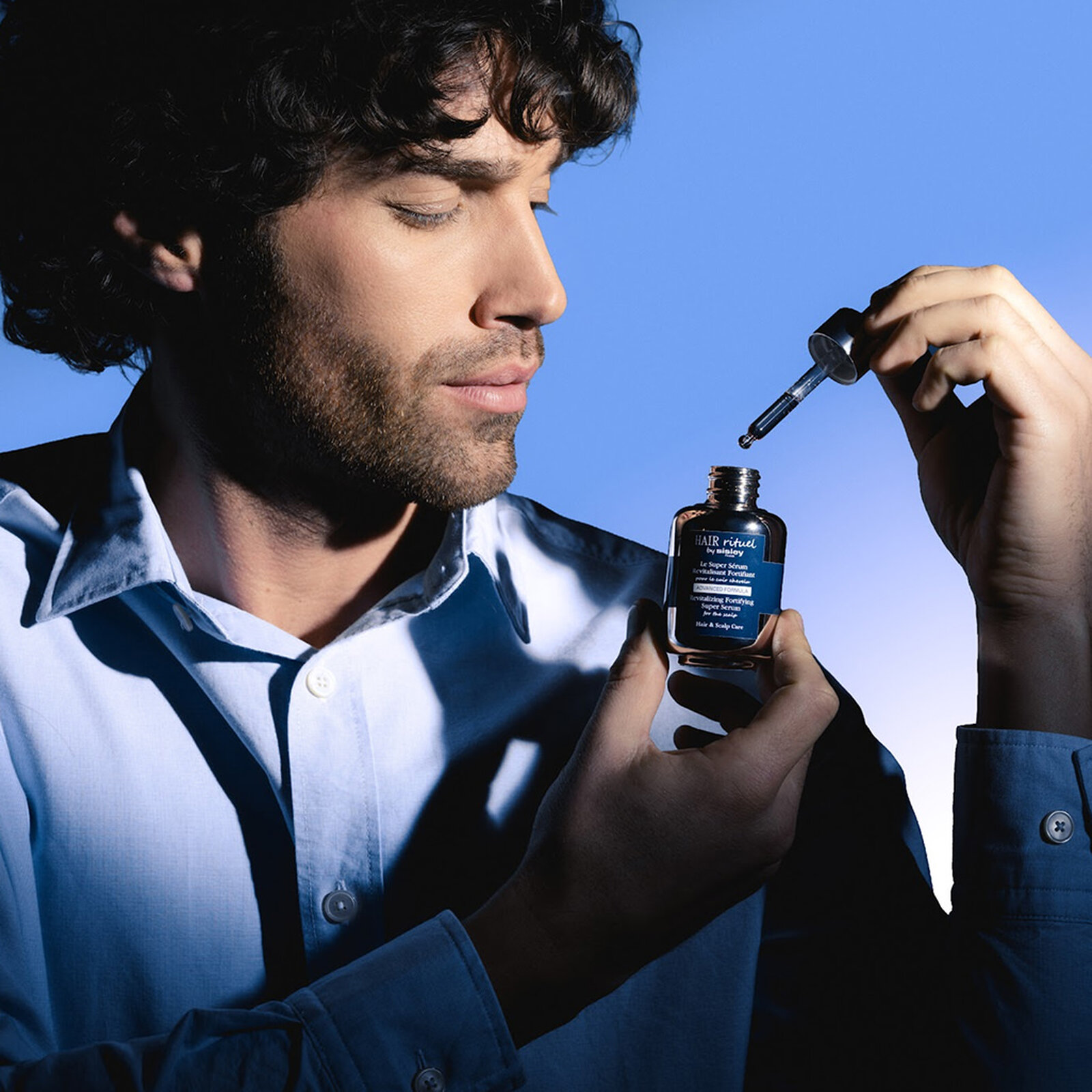 Man holding the Revitalizing Fortifying Shampoo