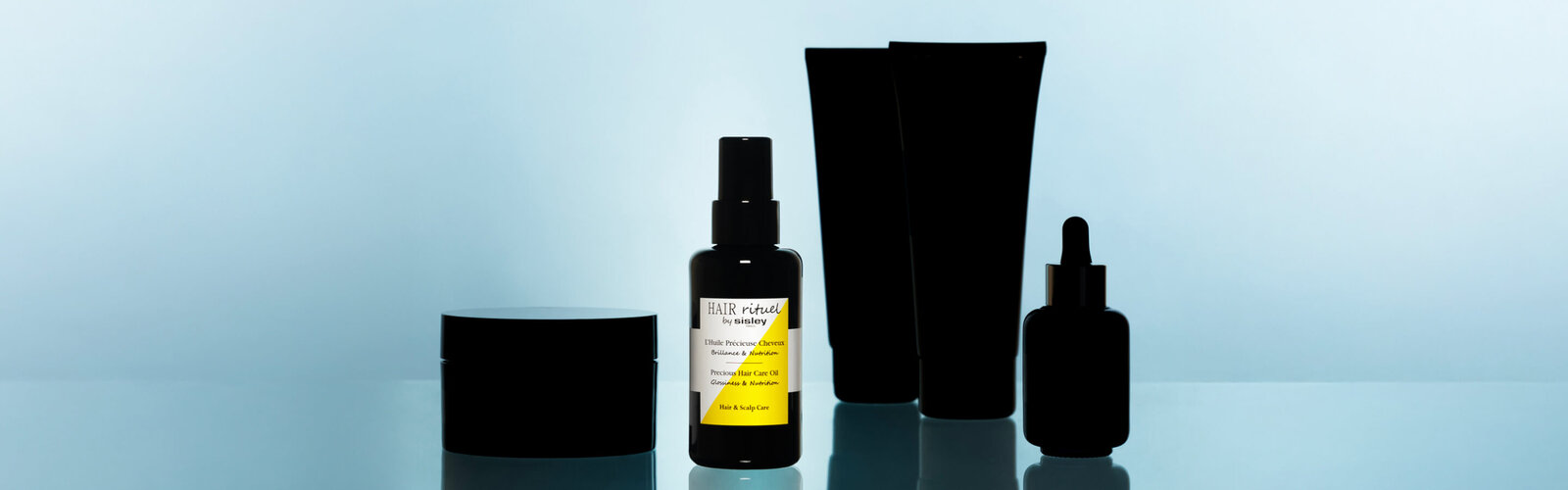 Precious Hair Care Oil bottle under the spotlight alongside other products from the Hair Rituel range